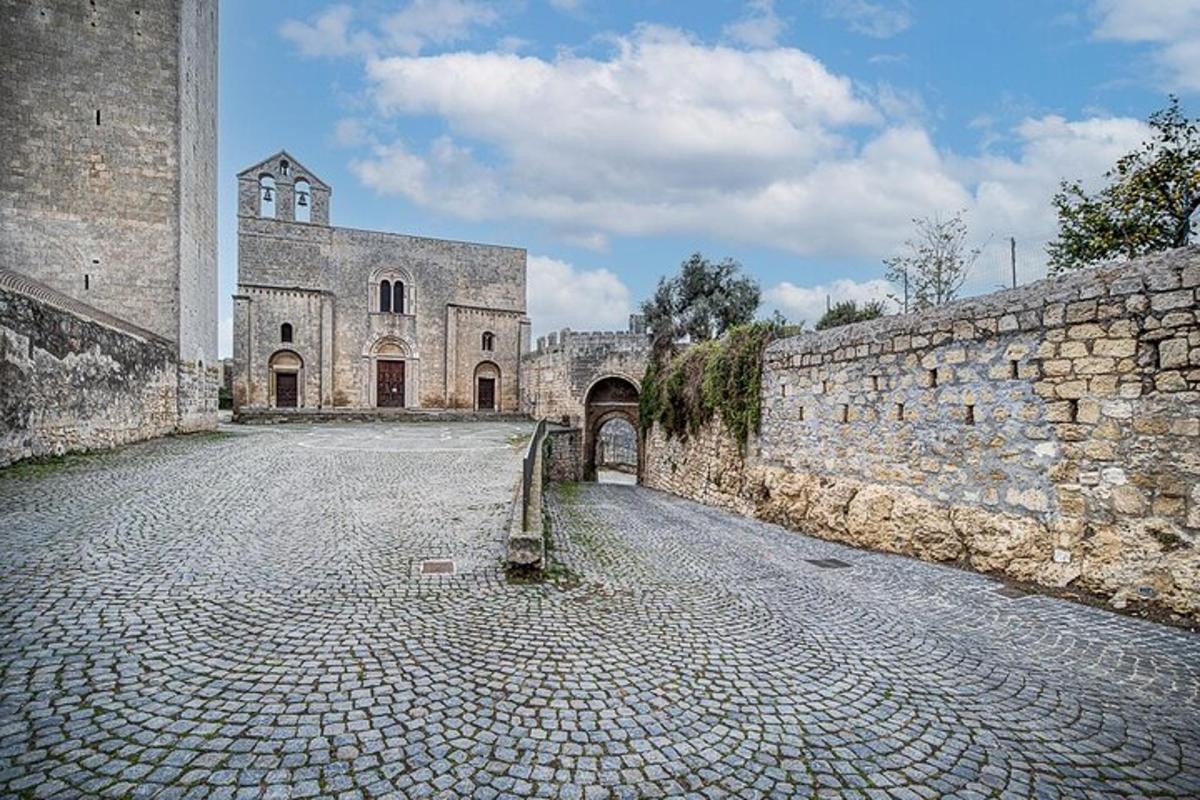 an old building with a stone street and a stone wall