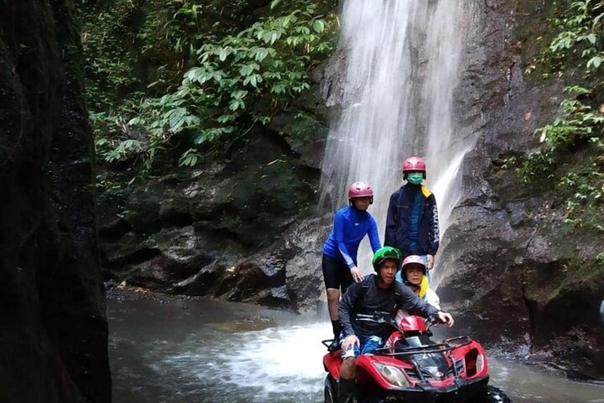 a group of people standing in front of a waterfall