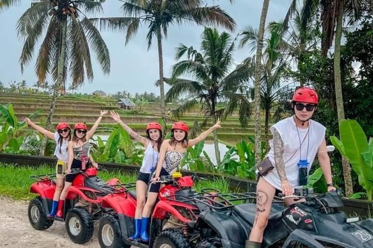 a group of people riding on quad bikes
