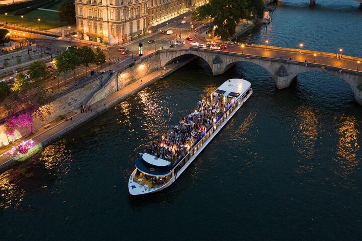 a boat full of people on the water under a bridge