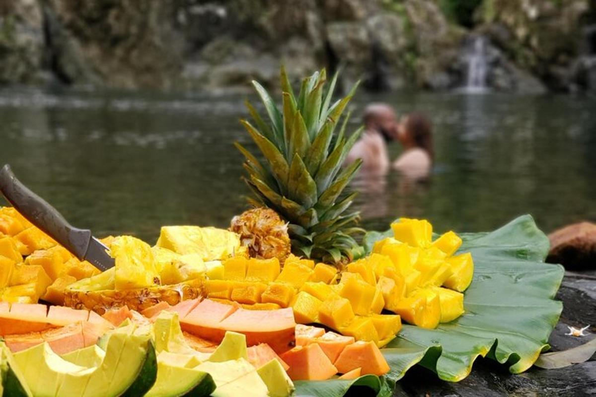 a pile of fruit on a leaf with a knife