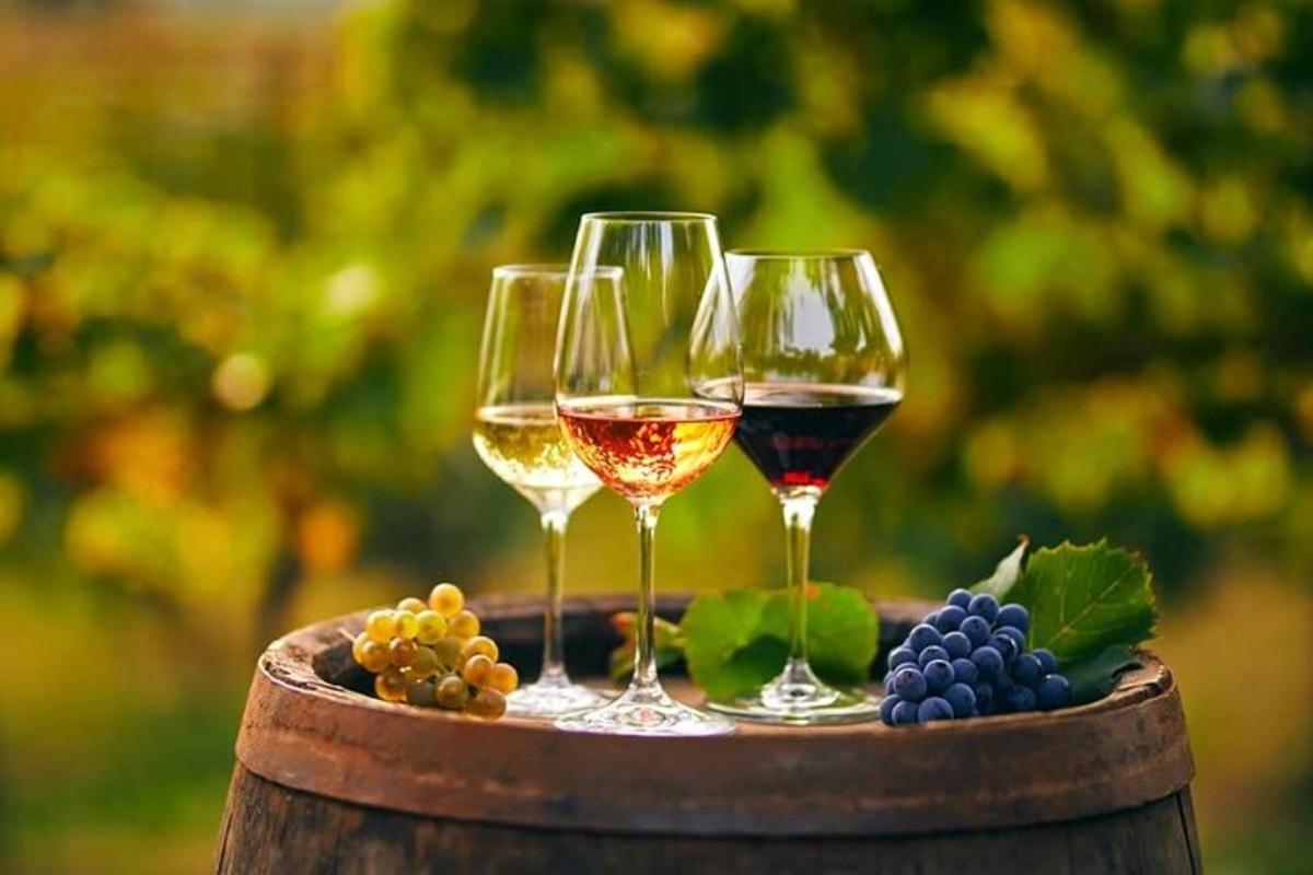 three wine glasses sitting on top of a barrel