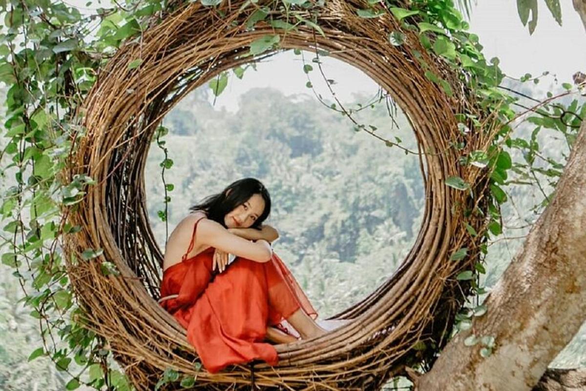 a woman in a red dress sitting in a basket