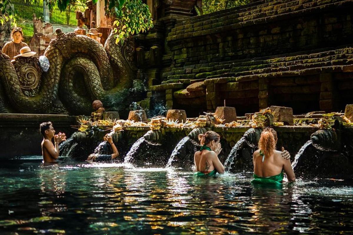 a group of people in the water in a fountain