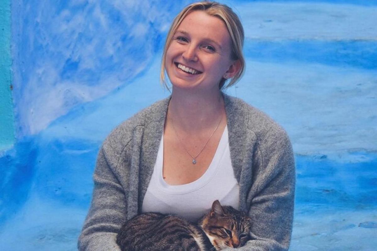 a woman holding a cat in her arms