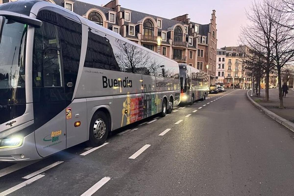 two buses parked on the side of a street