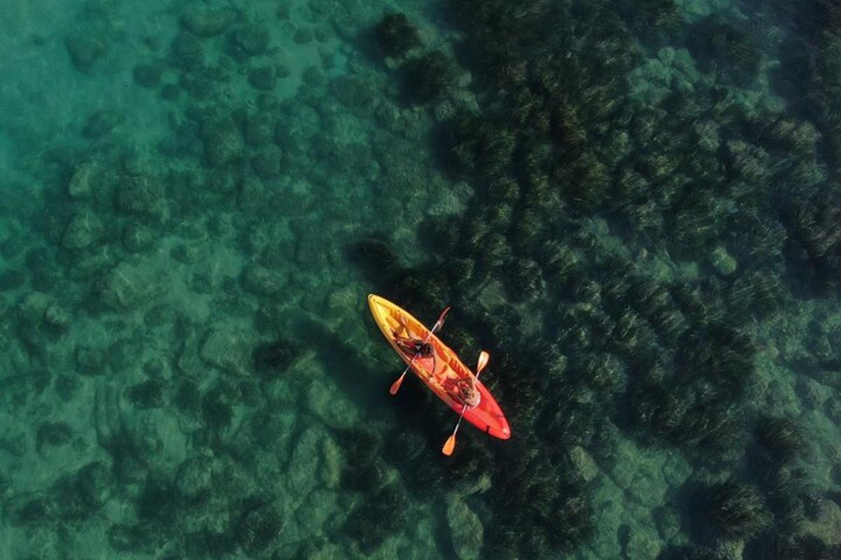 Un kayak rojo y amarillo en el agua.