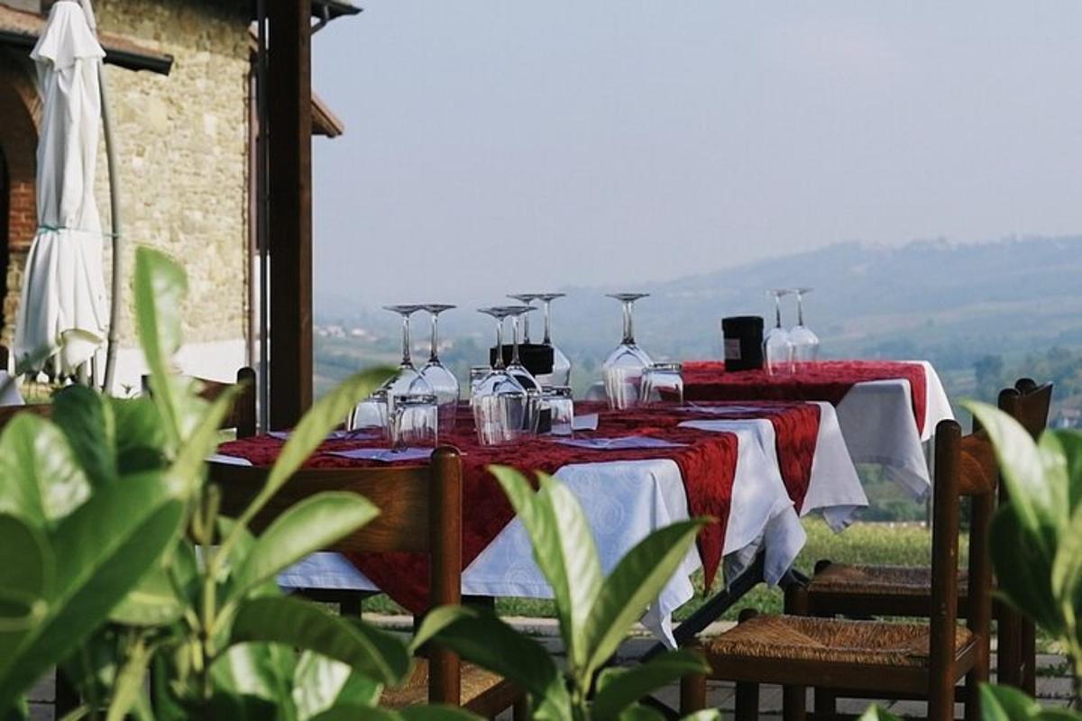 a table with red and white table cloths and wine glasses