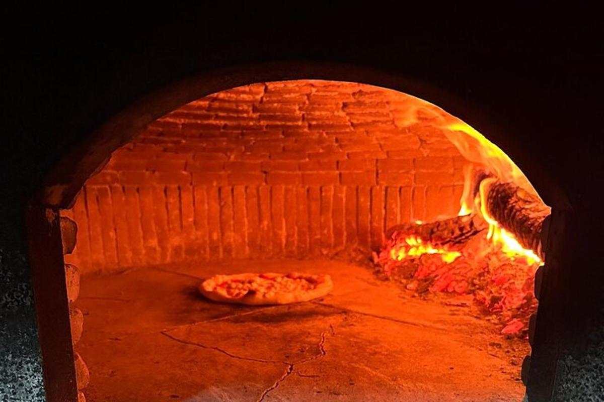 a large brick oven with a pizza in it