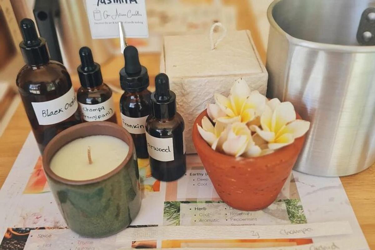 a table with bottles of essential oils and a candle