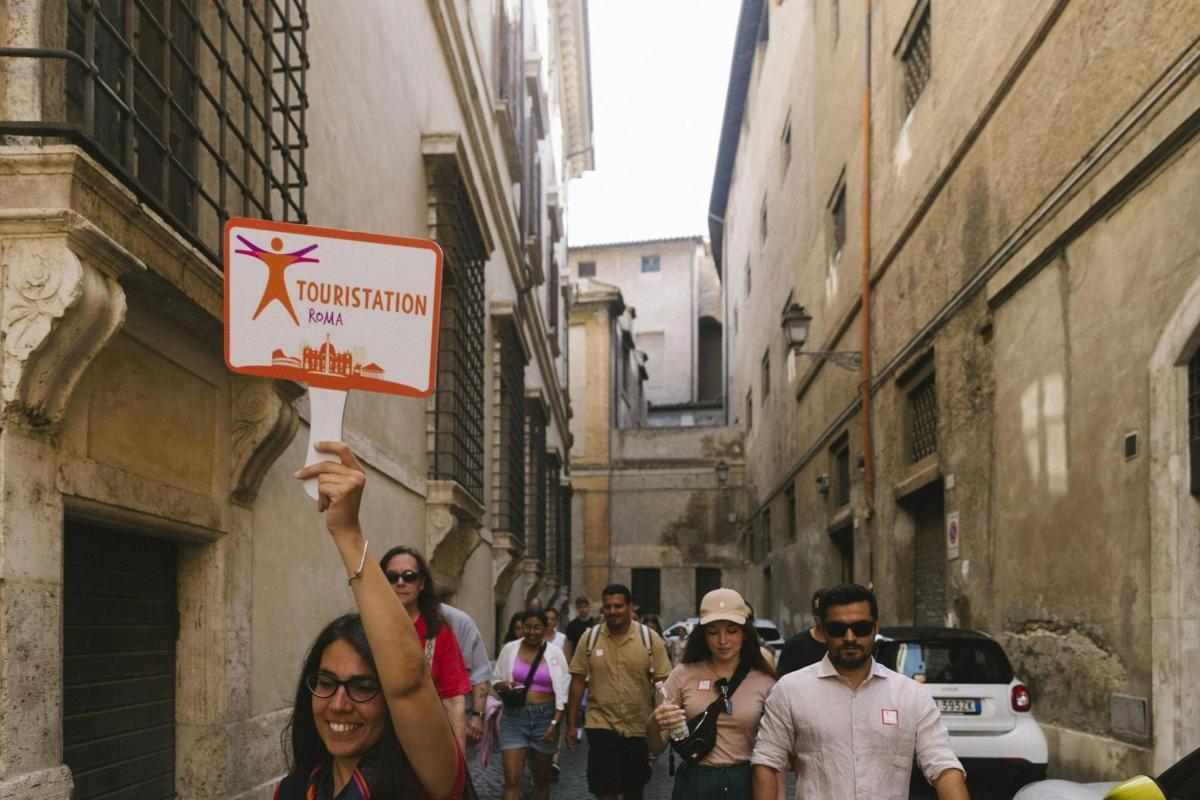 a woman holding up a sign in a street