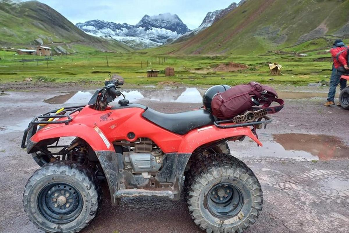 a red atv parked on the side of a mountain