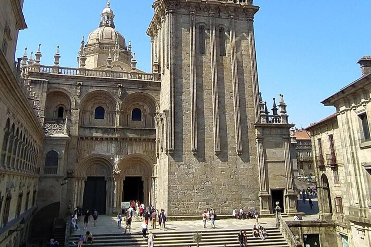 a large building with a clock tower with people walking around it