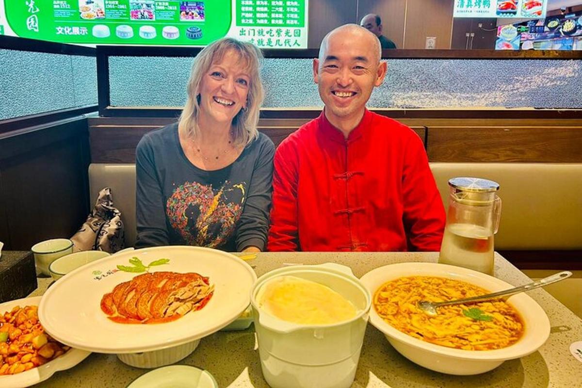 a man and woman sitting at a table with food