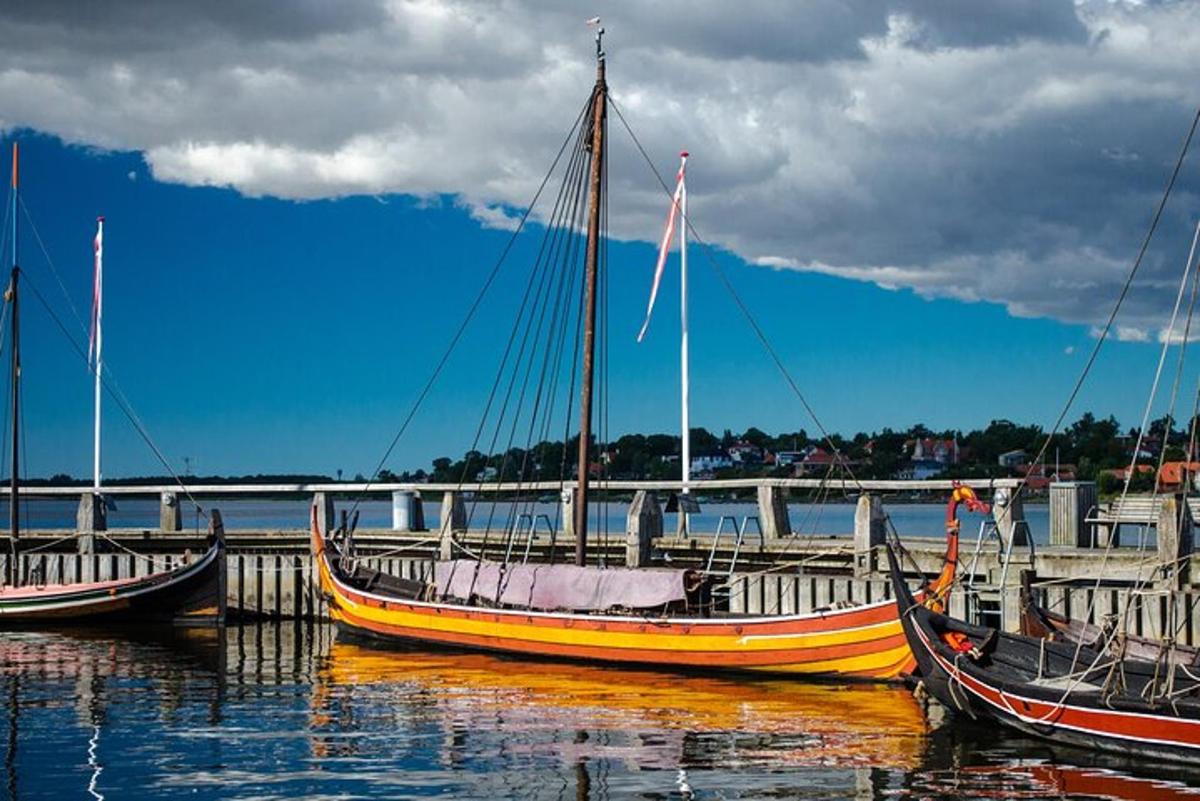 three boats are docked at a dock in the water