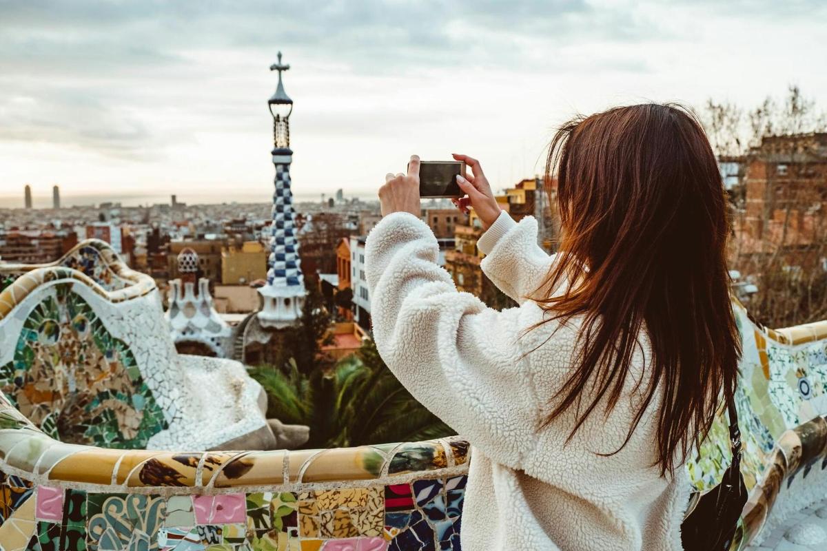 a woman taking a picture of a city