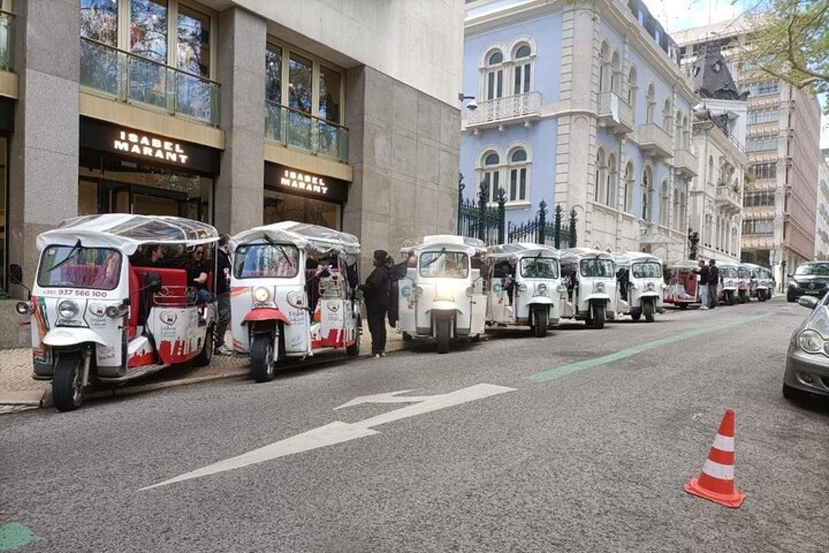 a row of white vehicles parked in a line on a street
