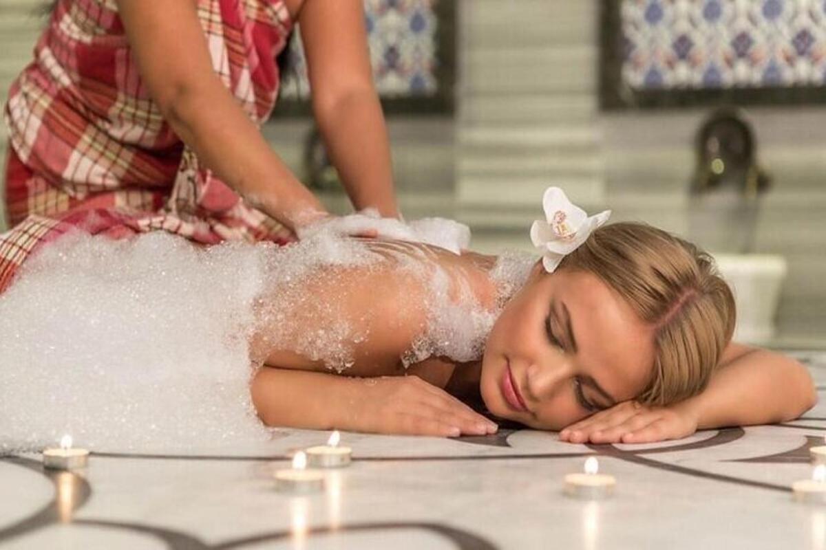 a woman getting a massage in a bath tub