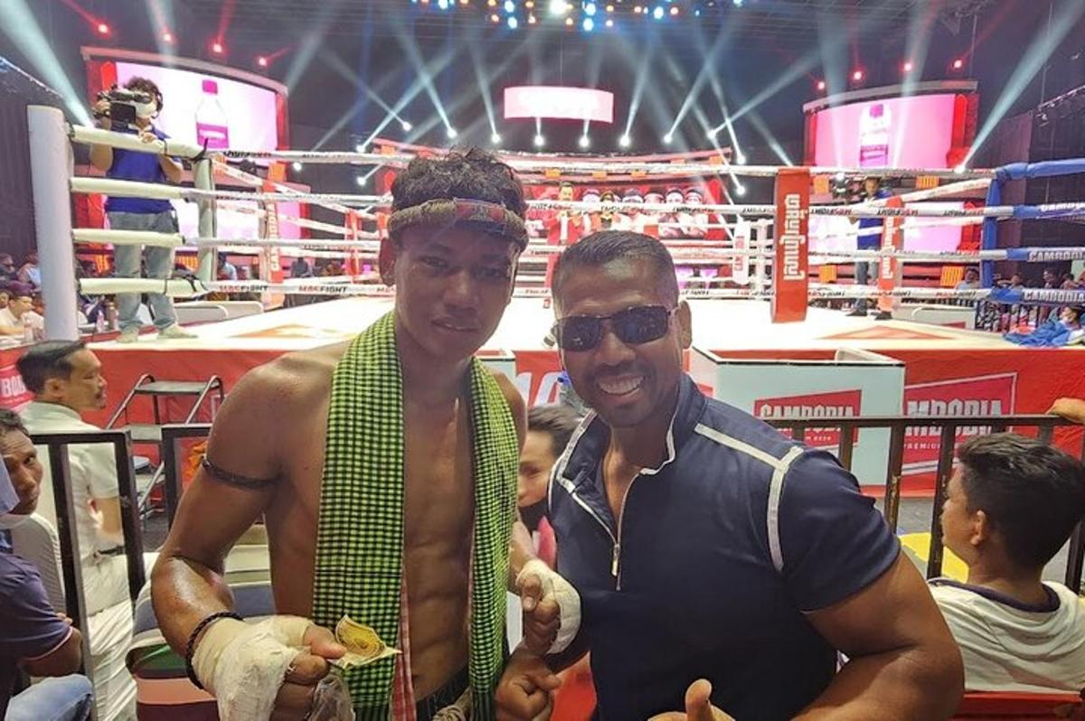 two men are standing in a boxing ring