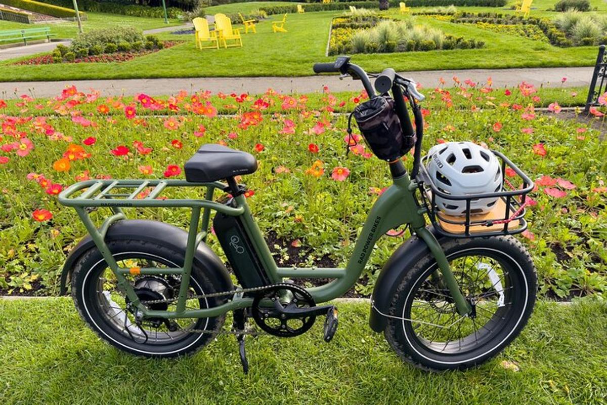 a bike parked in the grass with a helmet on it