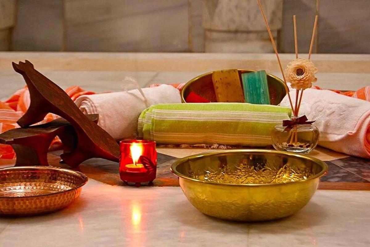 a table with shoes and a bowl and a candle