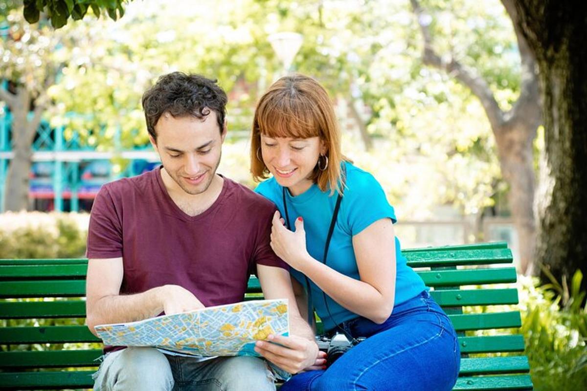 a man and woman sitting on a bench looking at a map