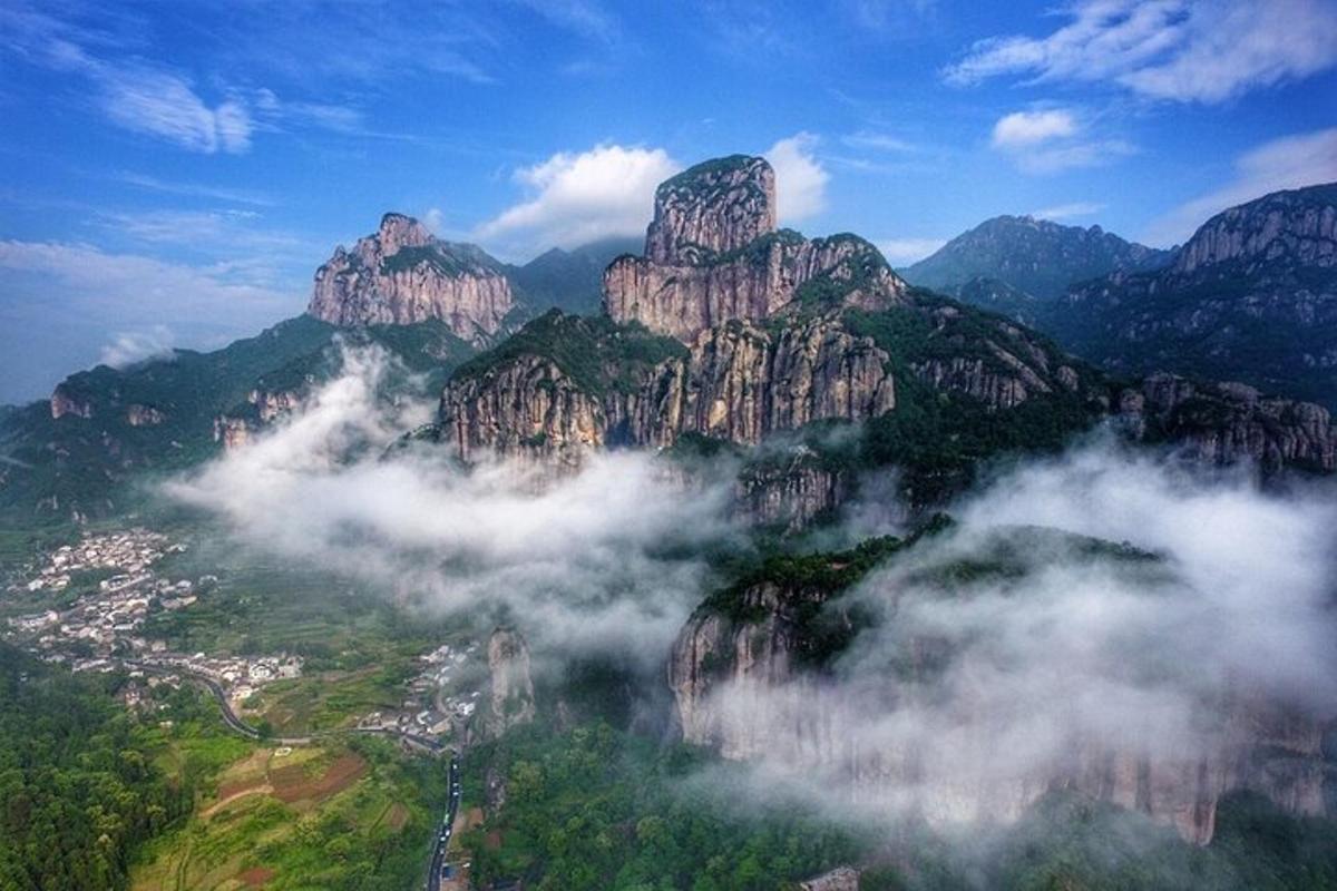 a view of a mountain village in the clouds