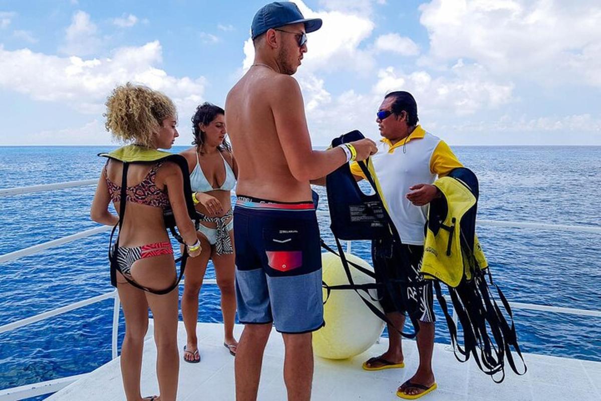 a group of people standing on the deck of a boat