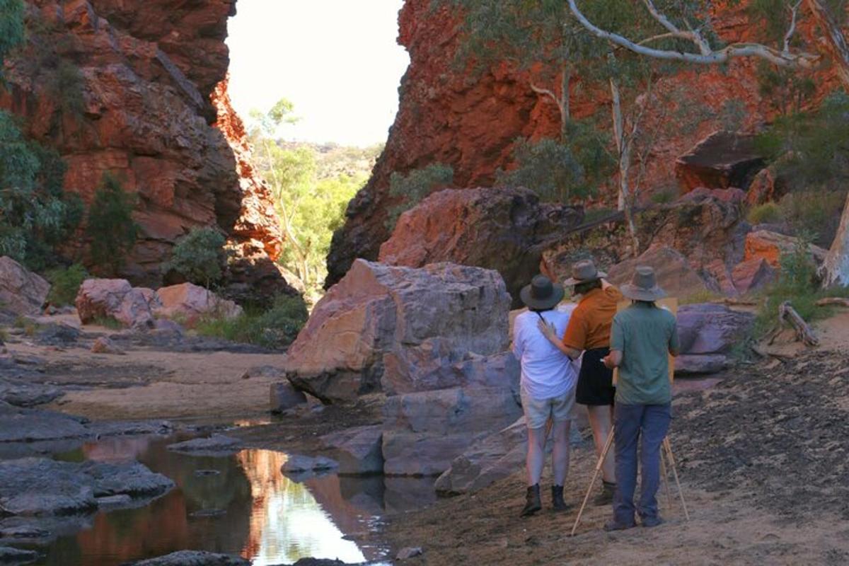 a group of people walking along a river