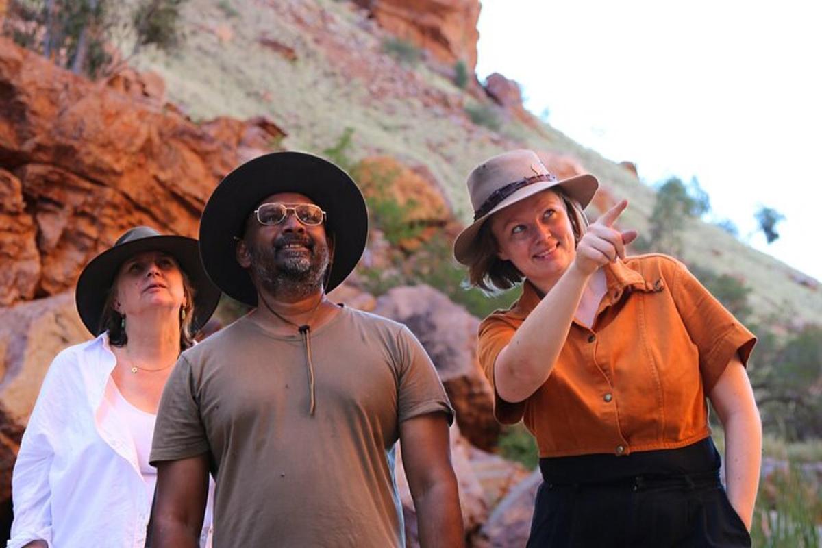 a group of people standing in front of a mountain