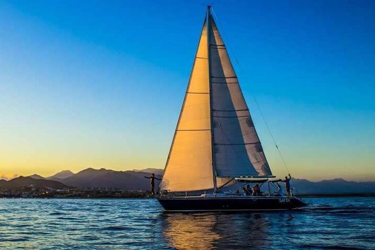 a sailboat on the water at sunset