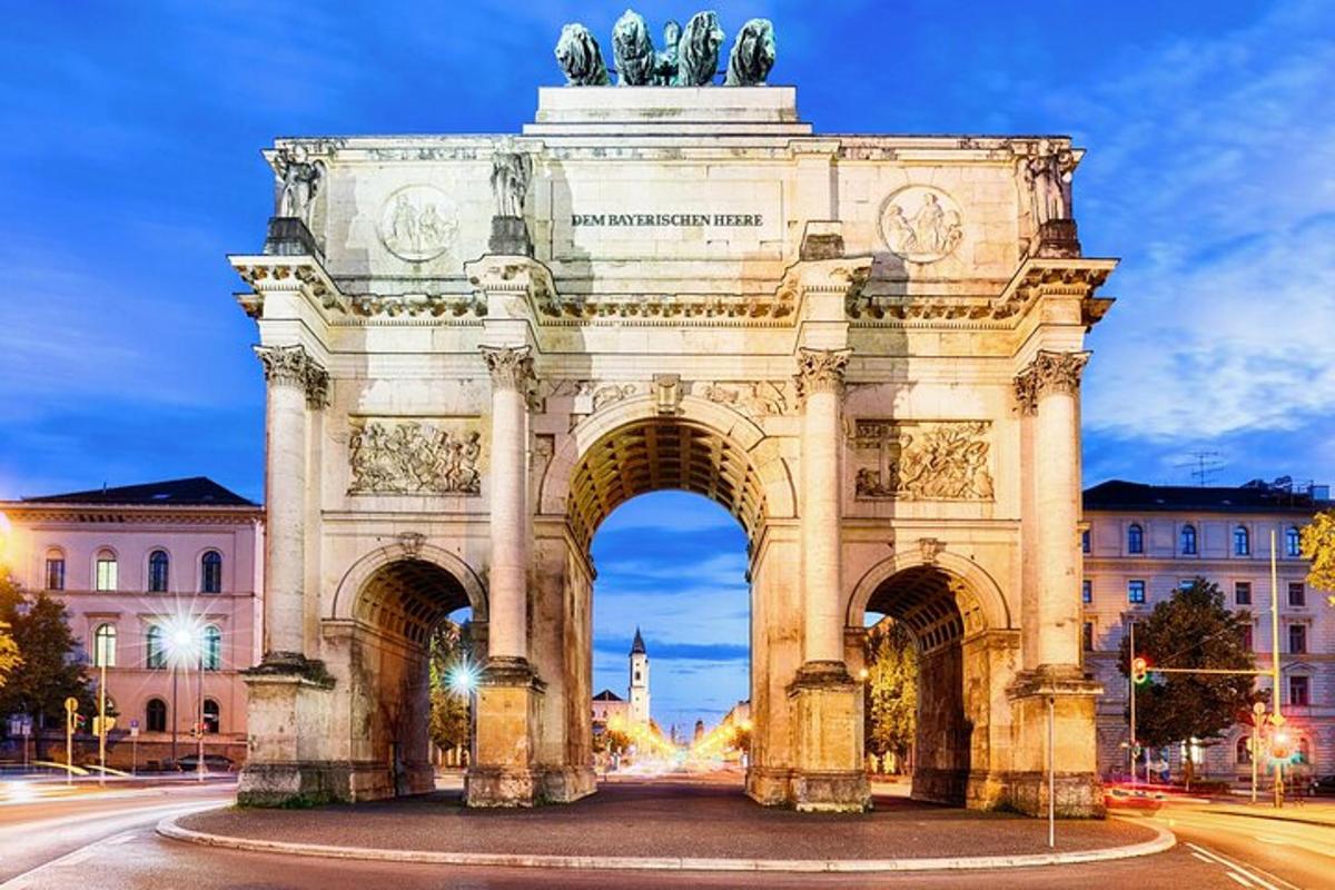 an arch with a statue in front of a building