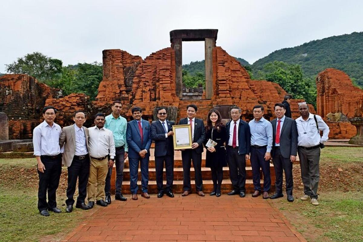 a group of people posing for a picture in front of a building
