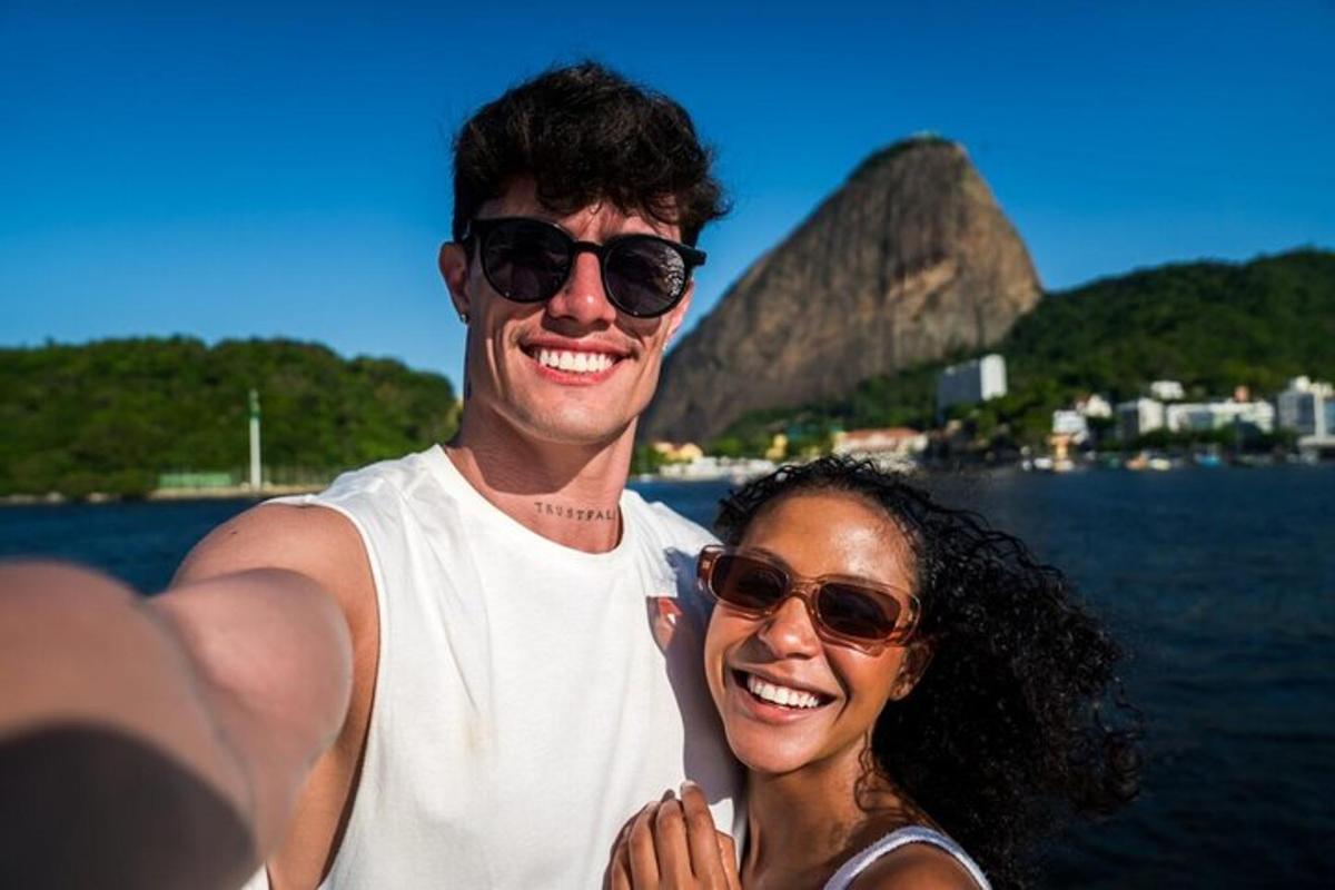 a man and a woman standing next to the water