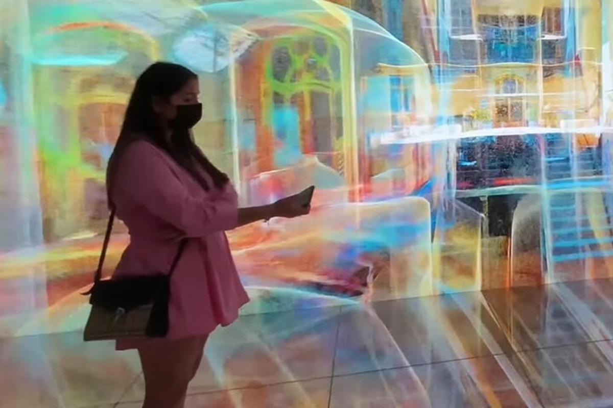 a woman standing in a room with a book
