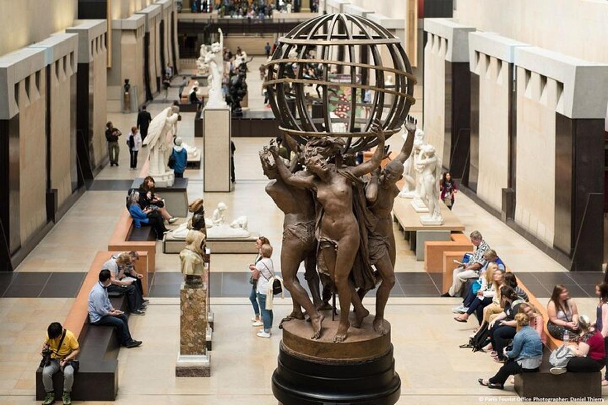 a statue of a woman holding a ball in a mall