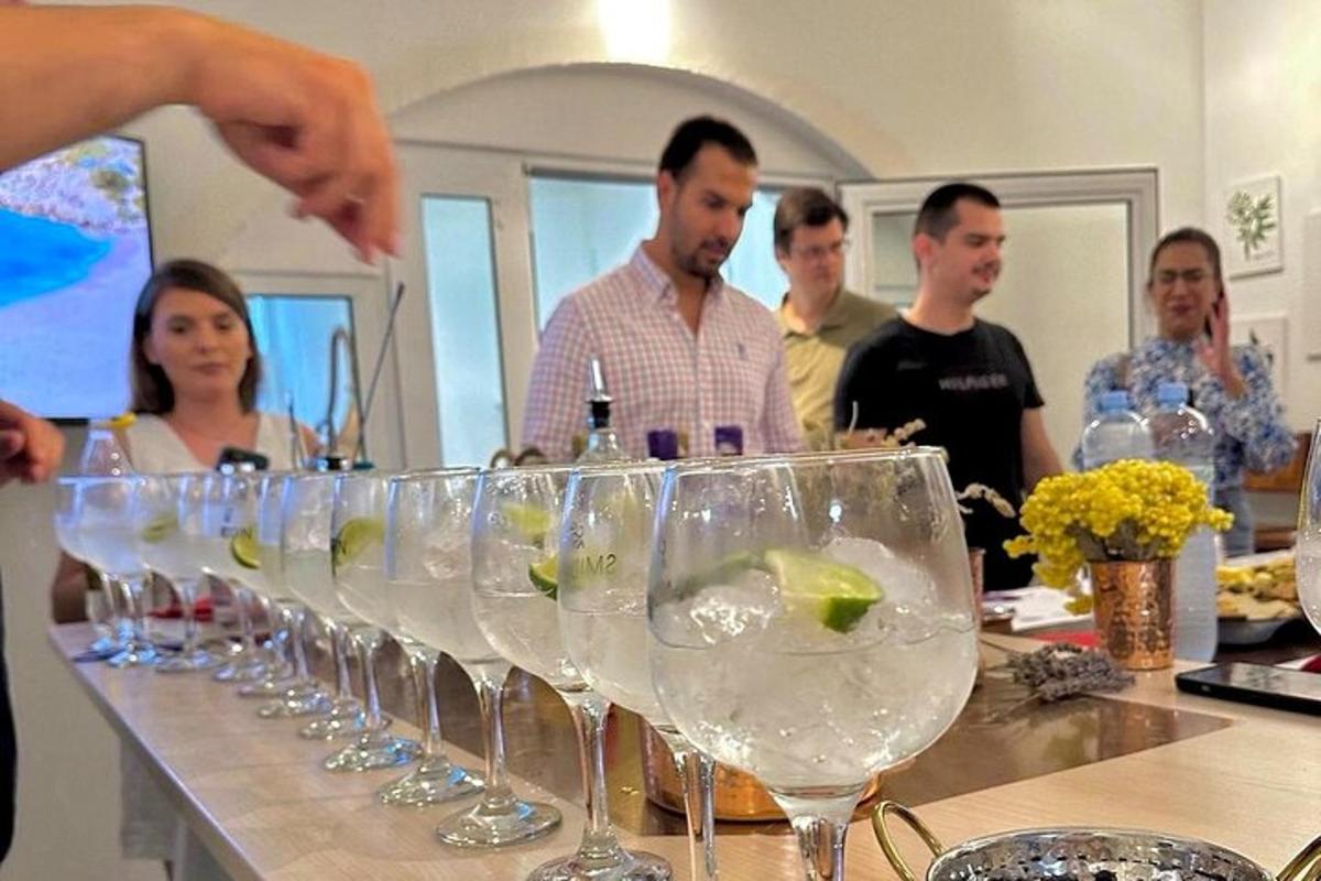 a group of people standing around a bar with wine glasses
