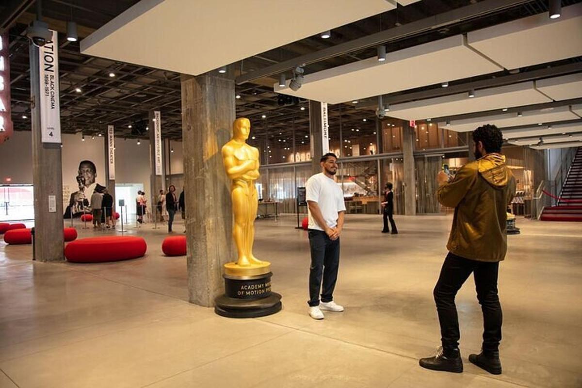 two men standing next to a statue in a museum