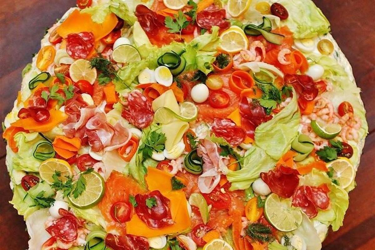 a pizza with various vegetables on a table