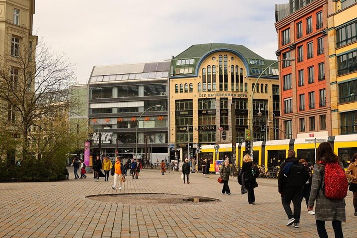 a group of people walking around a city with buildings