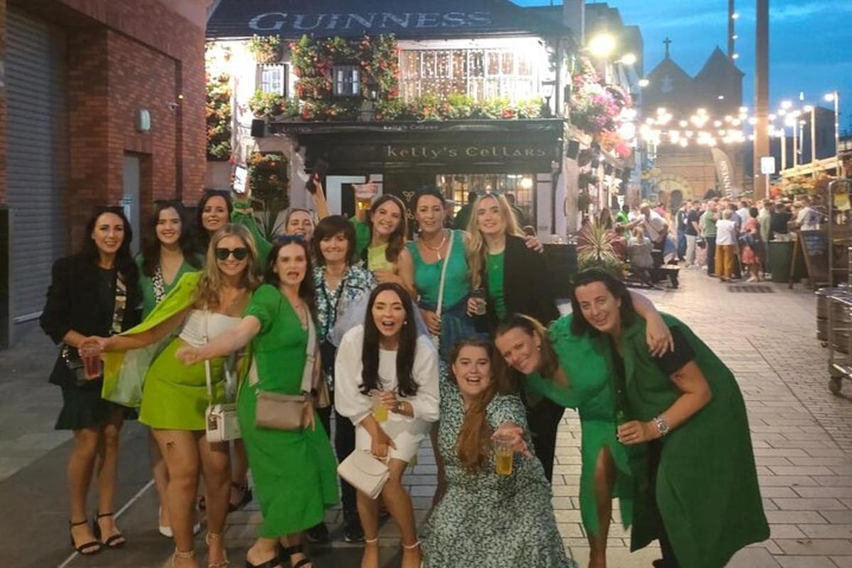 a group of women in green dresses posing for a picture