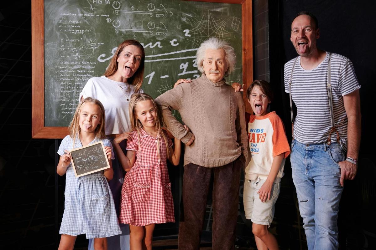 a family posing for a picture in front of a chalkboard