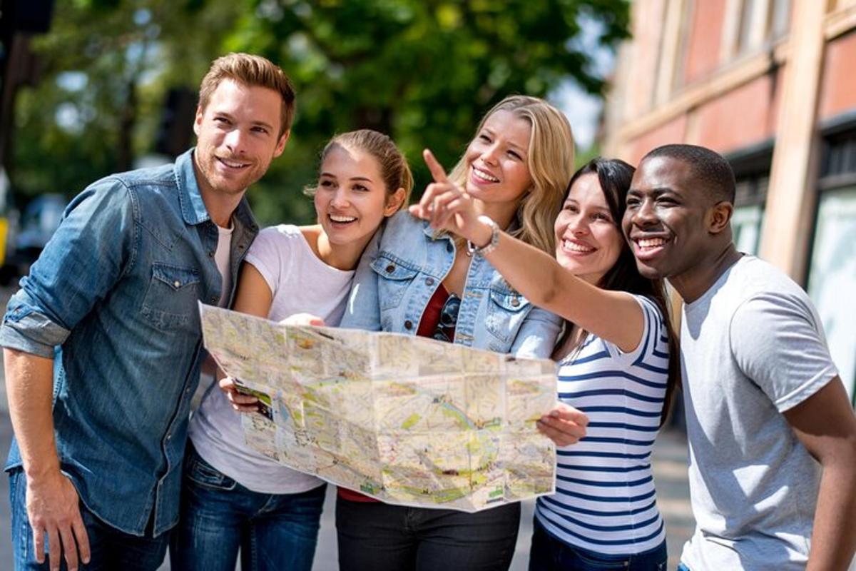 a group of people standing together holding a map