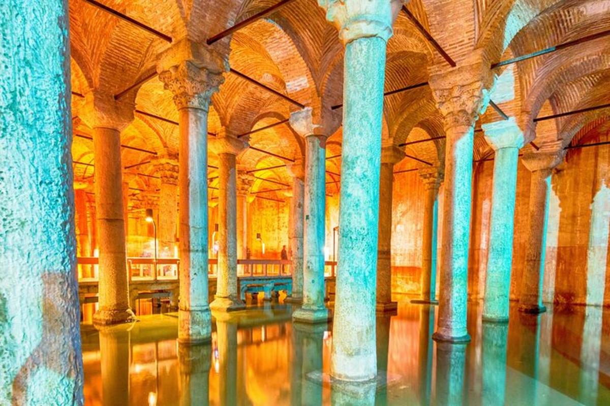 a large room with columns and water in a building