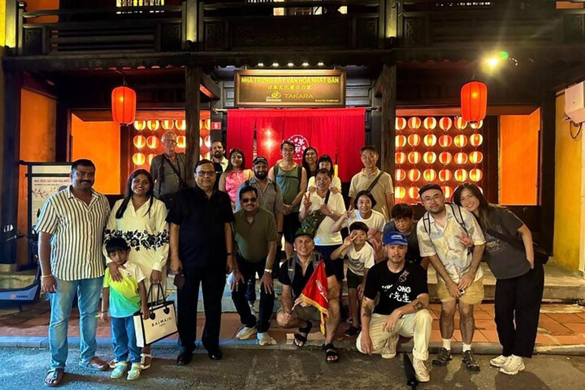 a group of people posing for a picture in front of a building