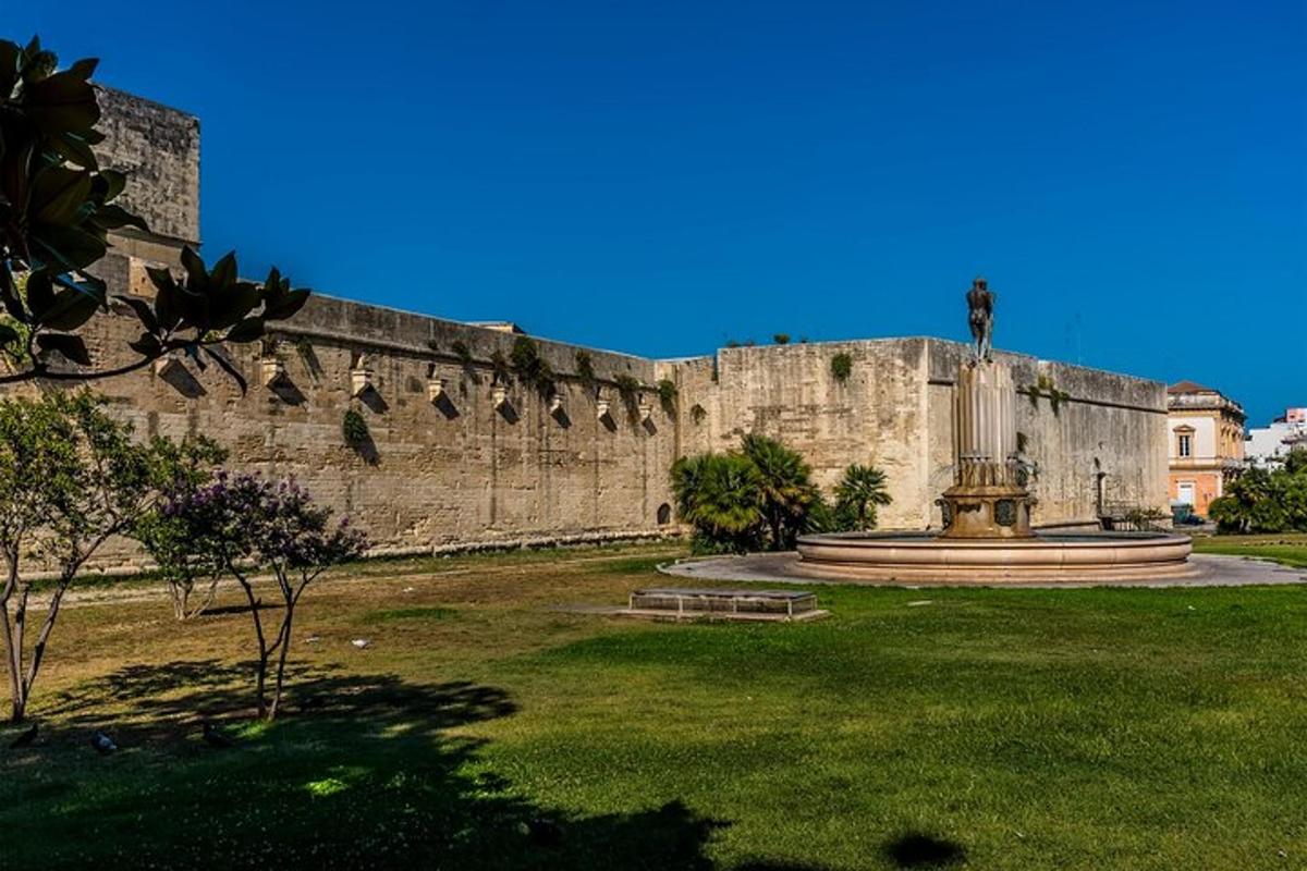 un grande muro di pietra con una statua di fronte