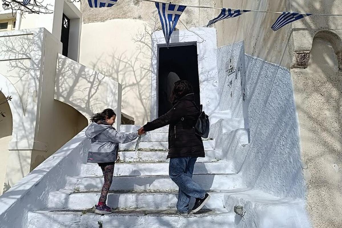 a man and a woman walking down snow covered stairs