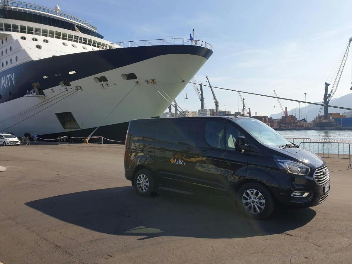 a black van parked in front of a cruise ship