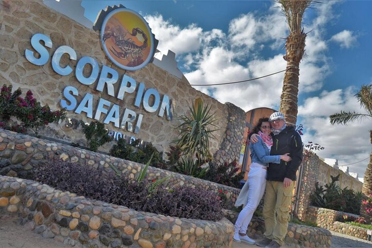 two people standing in front of the entrance to the resort