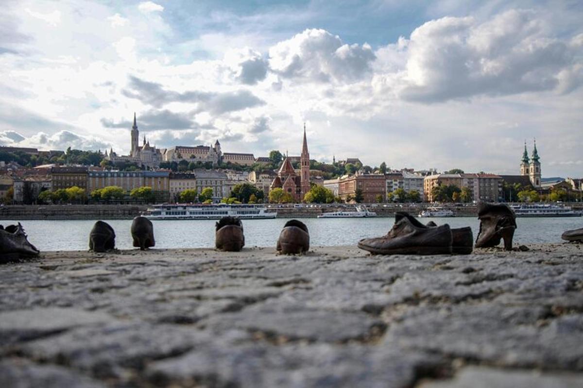 a group of shoes sitting on the ground near the water
